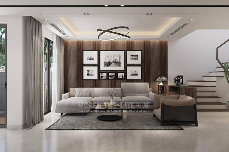 Thiết kế tường phòng khách đẹp độc đáo với gỗ ốp tường kết hợp tranh đen trắng phong cảnh. Thiết kế biệt thự